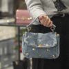 Tracollina denim borchiette