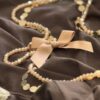 Collana lunga fiocchetto beige